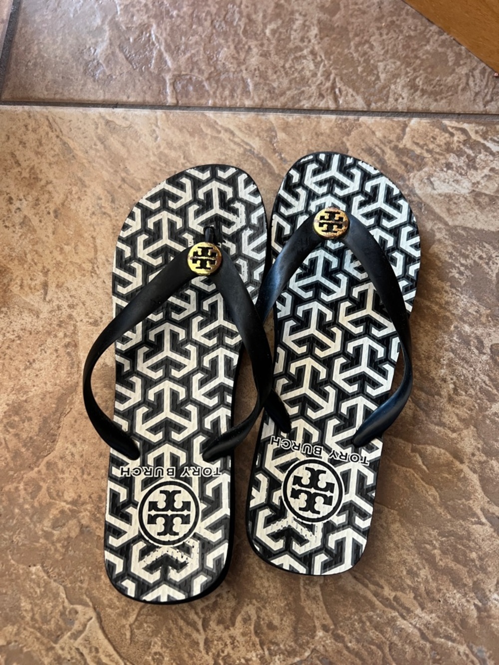 Tory Burch Black and White Geometric Logo Flip Flops with Gold Emblem